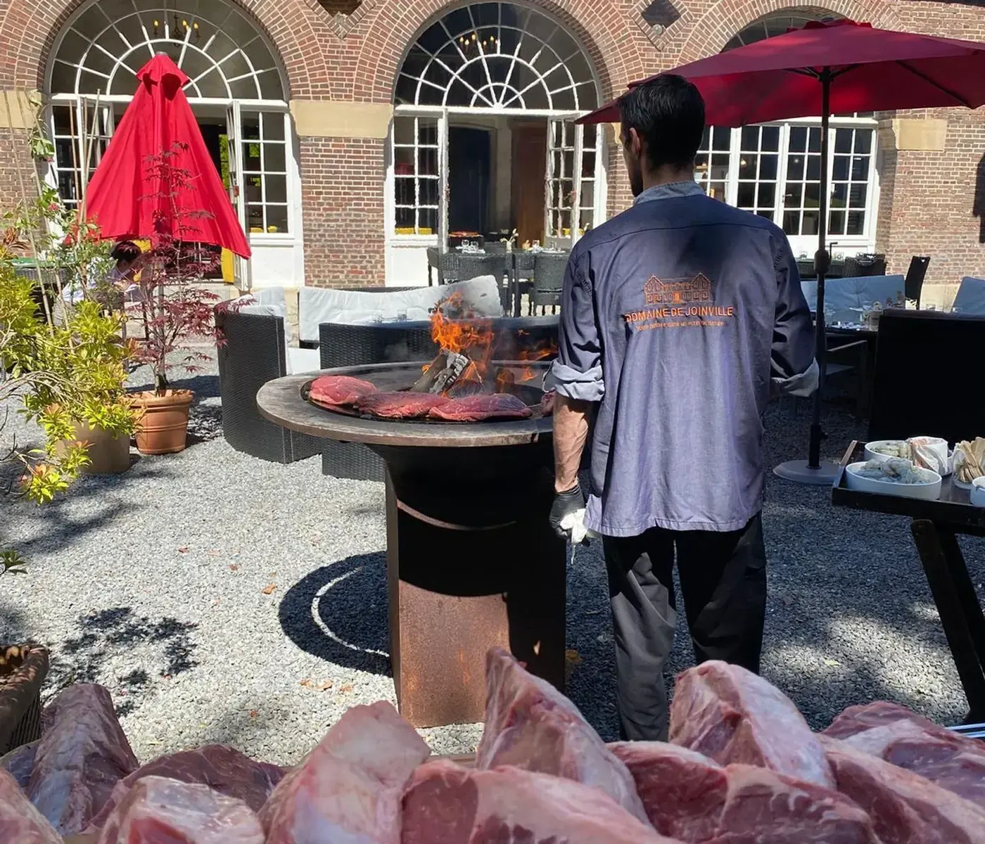 Un cuisinier du Domaine à la plancha, en terrasse